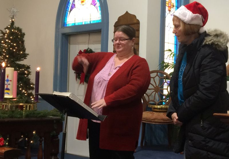 in the front of a church, a speaker and a signer lead.