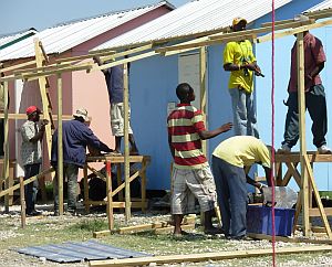 people building houses at the village in Haiti