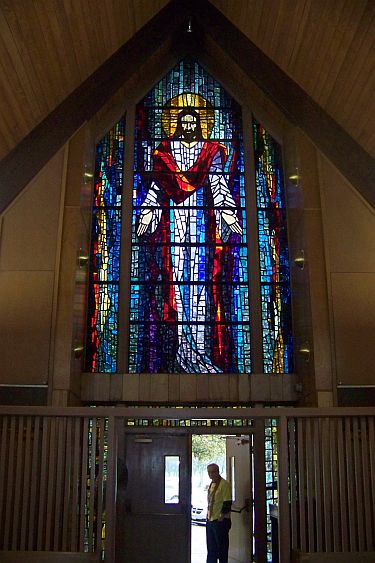 chapel at mission home, stained glass of Jesus holding hands in outreach