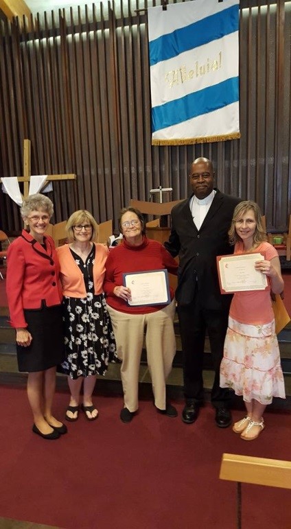 photo of: Bishop Peggy Johnson, Rev. Anne Pruett-Barnett (pastor of Grace UMC), Ms. Carol Stevens (new CLM), Rev. Derrick Porter (District Superintendent of the Wilmington District), Ms. Karen Miller (new CLM). Karen Miller is the first Deaf Certified Lay Minister in the history of the conference.